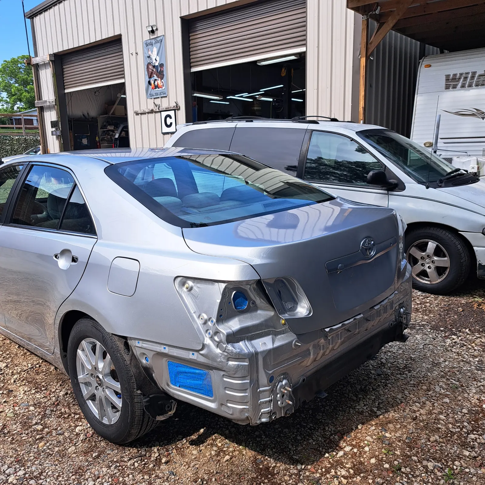 Silver sedan with rear bumper removed during collision repair — The ARK Body Shop and Collision Center in Concord