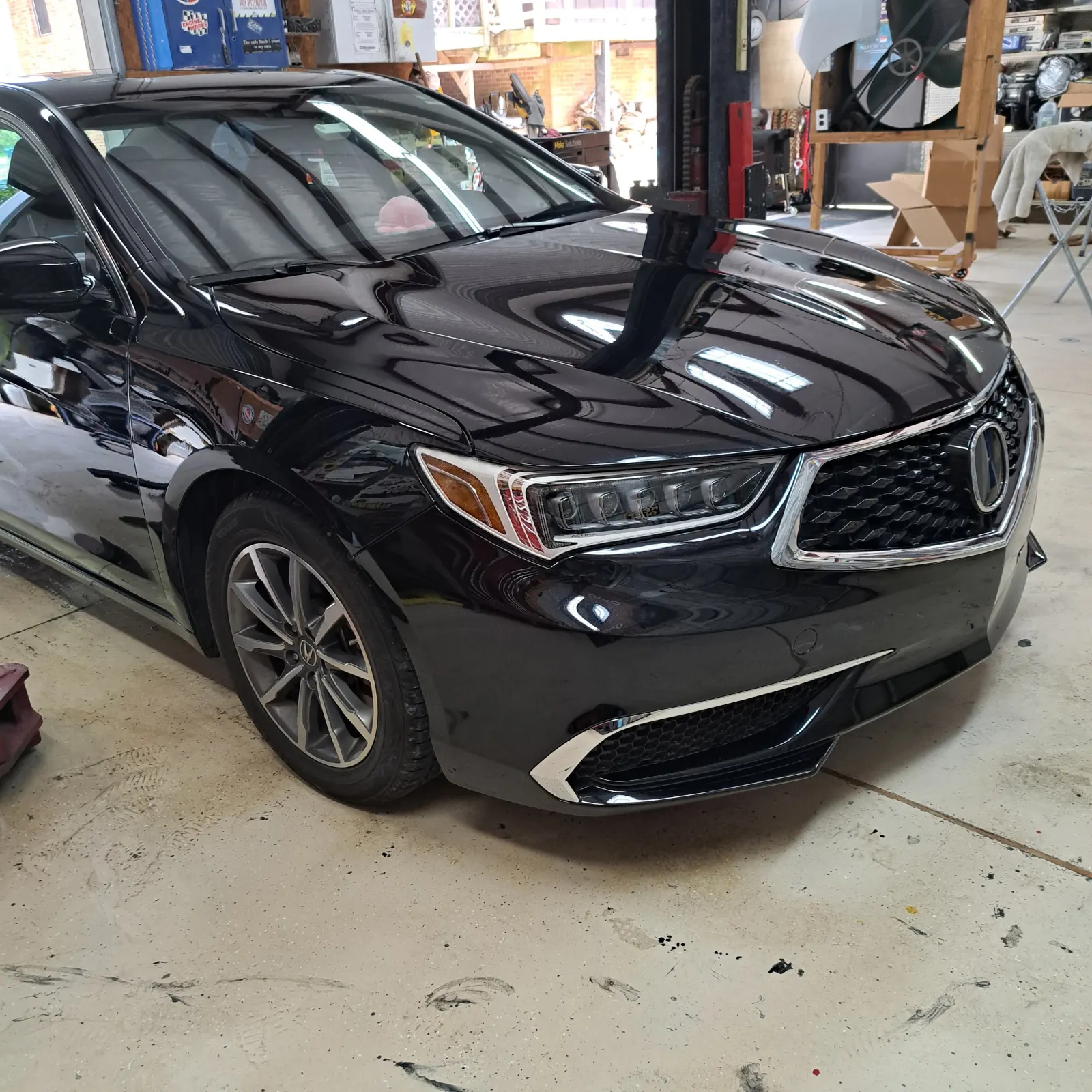 Polished black luxury sedan with glossy clear coat finish — The ARK Body Shop and Collision Center in Concord