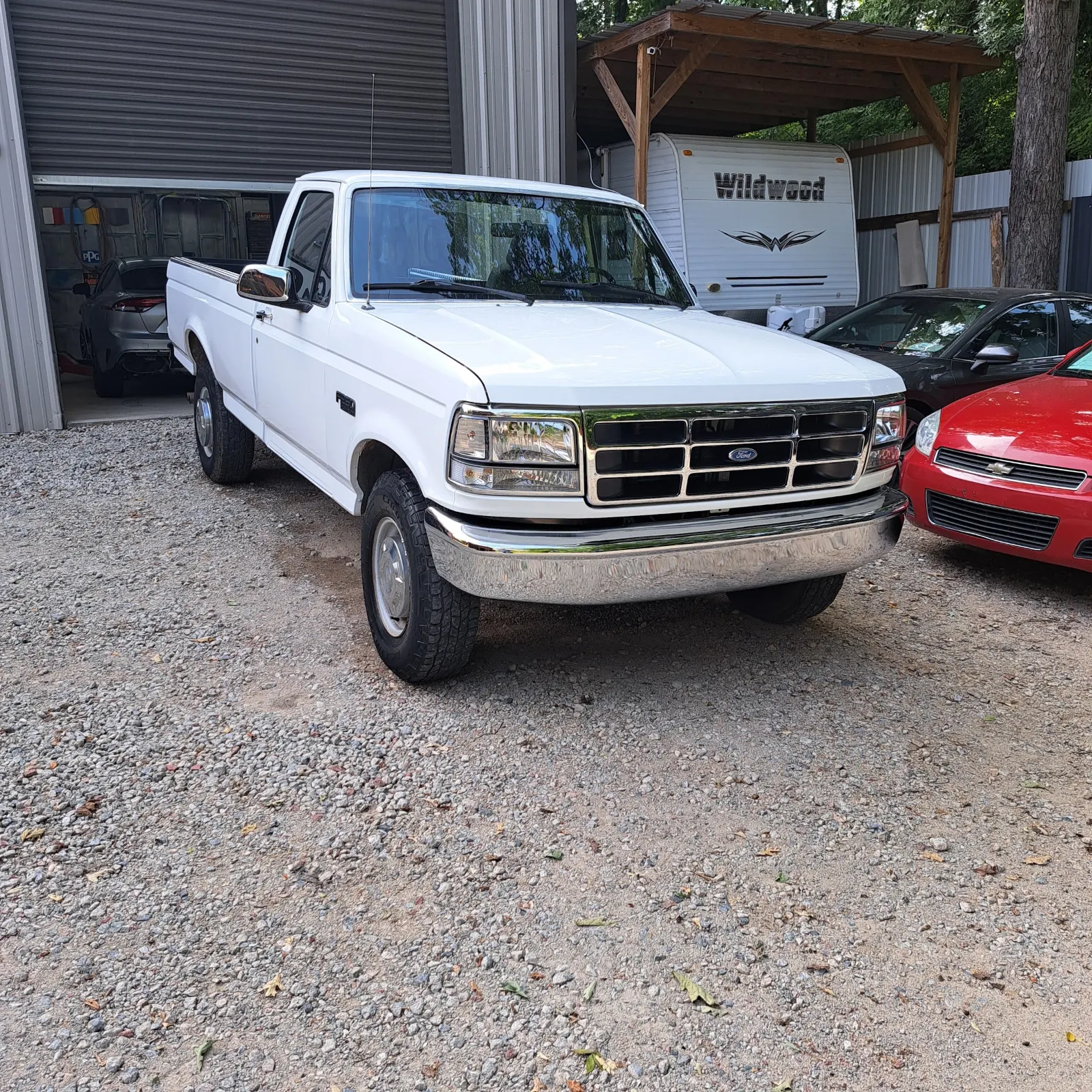 Restored white classic pickup truck parked outside repair bay — The ARK Body Shop and Collision Center in Concord