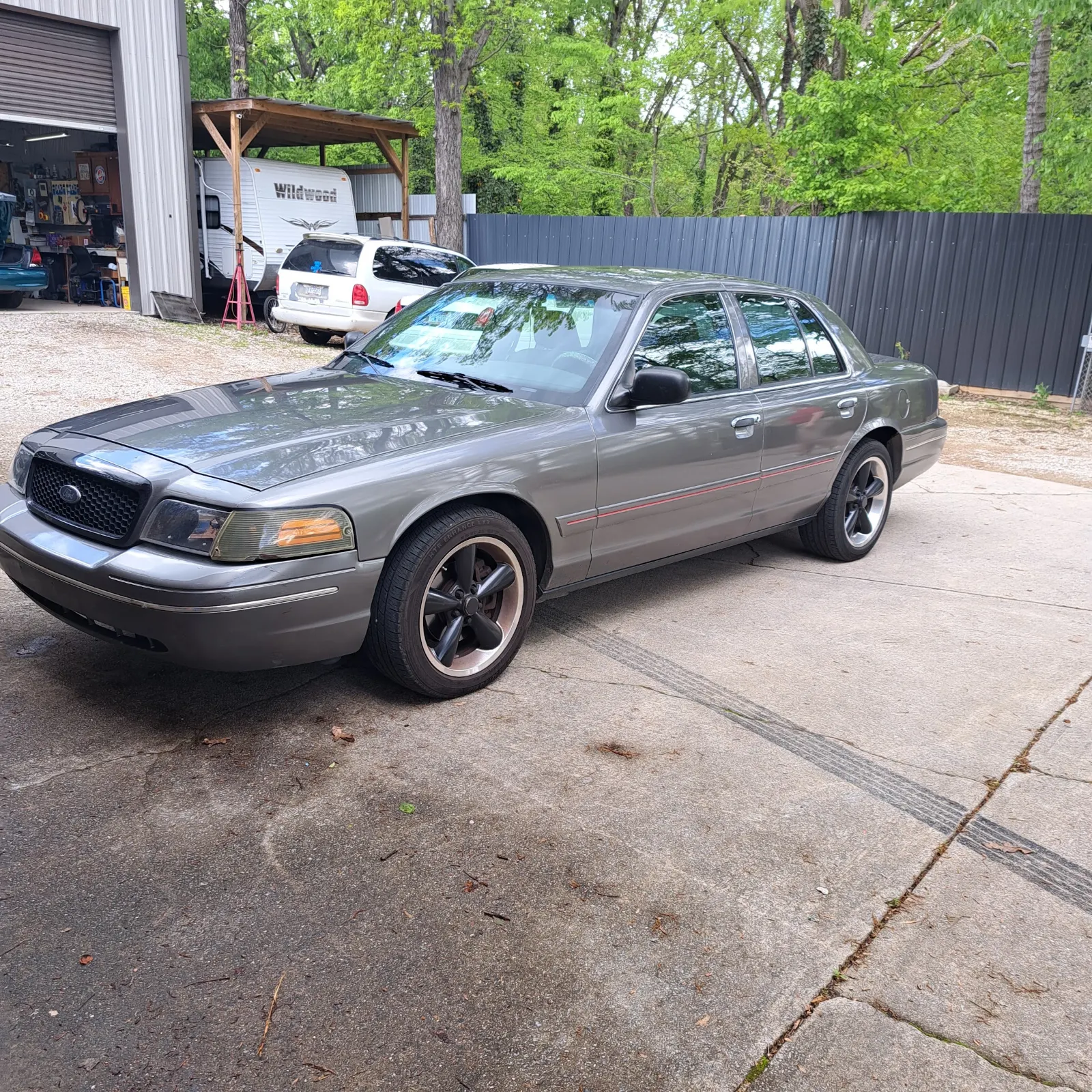 Repaired grey sedan parked on concrete apron outside shop — The ARK Body Shop and Collision Center in Concord